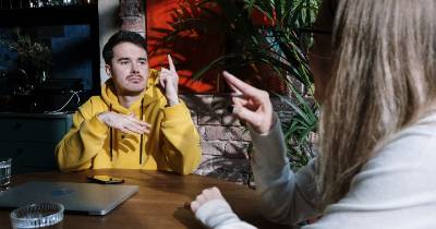 A couple conversing in sign language.